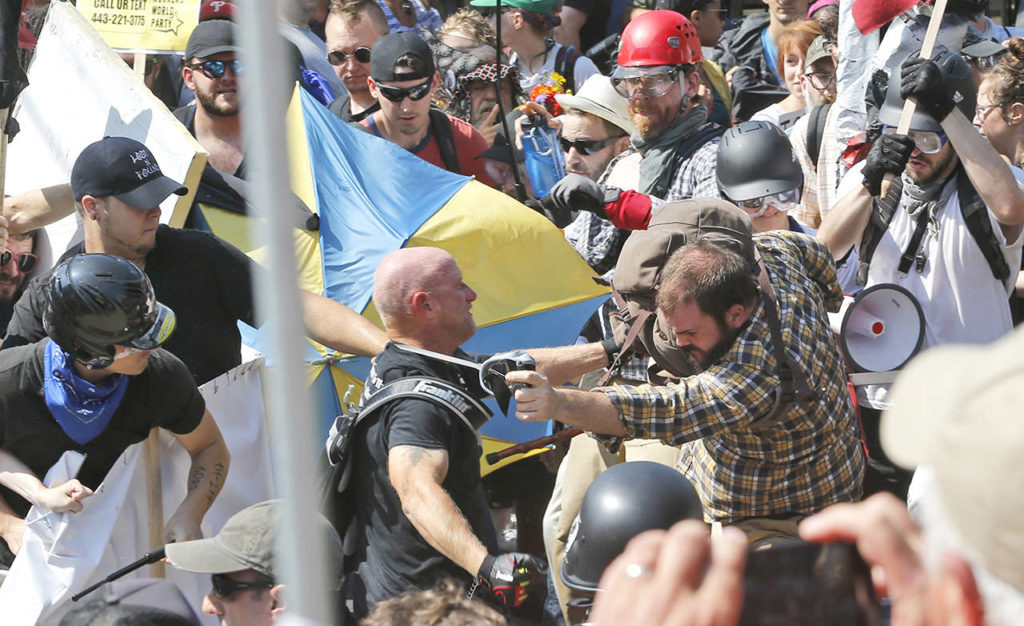 White nationalist demonstrators clash with counter demonstrators at the entrance to Lee Park in Charlottesville, Virginia, on Saturday. (AP Photo/Steve Helber)
