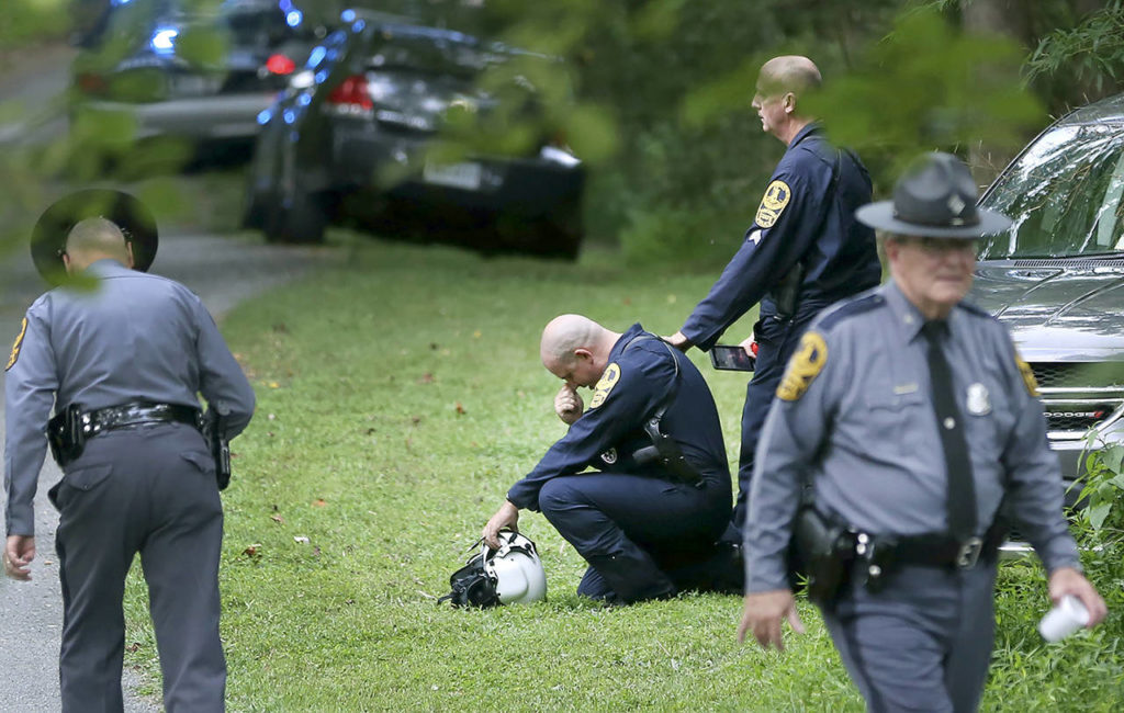 Authorities work near the scene of a deadly helicopter crash near Charlottesville, Virginia, on Saturday. (Shelby Lum/Richmond Times-Dispatch via AP)
