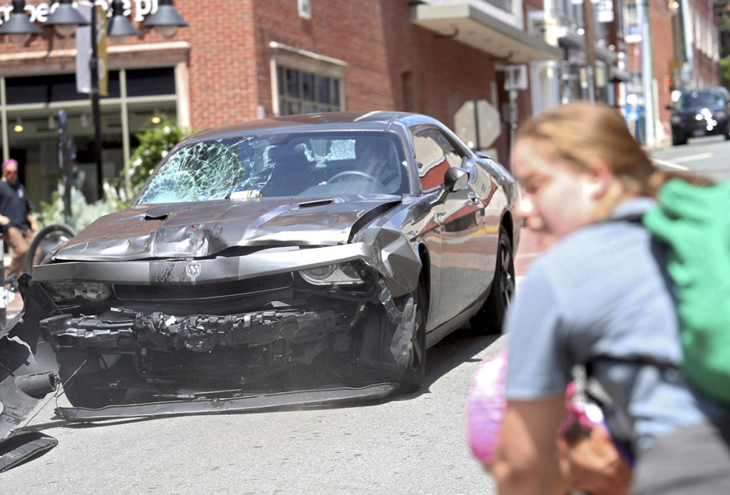 A vehicle reverses after driving into a group of protesters demonstrating against a white nationalist rally in Charlottesville, Virginia, on Saturday. (Ryan M. Kelly/The Daily Progress via AP)
