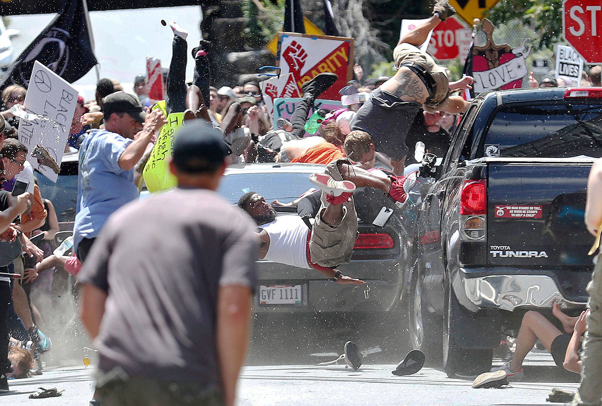 People fly into the air as a vehicle drives into a group of protesters demonstrating against a white nationalist rally in Charlottesville, Virginia, on Saturday. One woman was killed. (Ryan M. Kelly/The Daily Progress via AP)