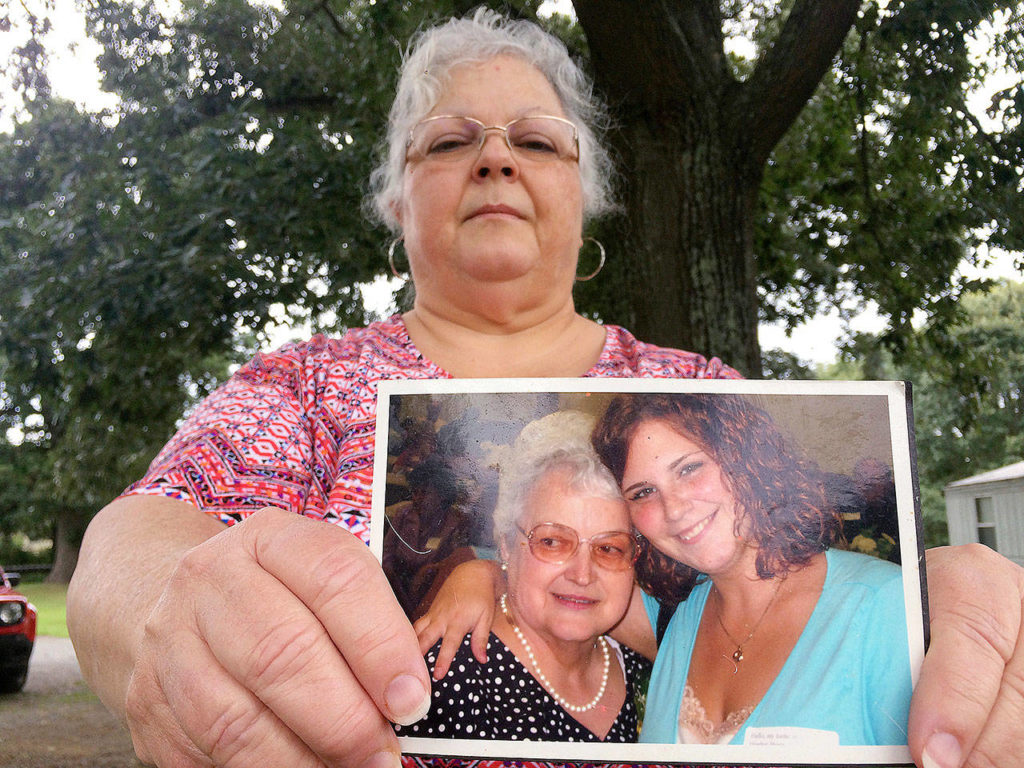 Susan Bro, the mother of Heather Heyer, holds a photo of Bro’s mother and her daughter (at right) on Monday. (AP Photo/Joshua Replogle) 
