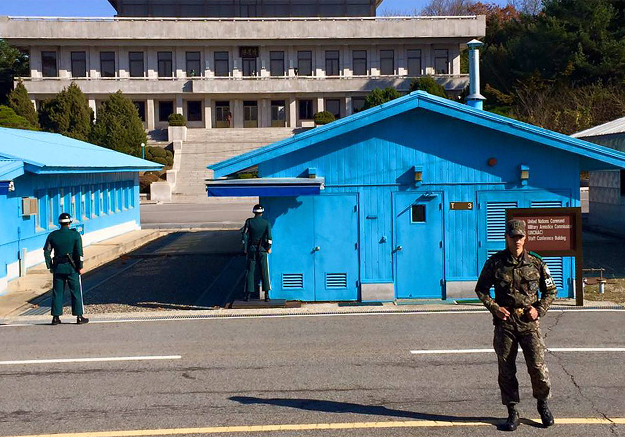 Soldiers stand guard on the South Korean side of the Joint Security Area in the Demilitarized Zone. The building in back is a North Korean command post. (Andrea Brown/The Herald)