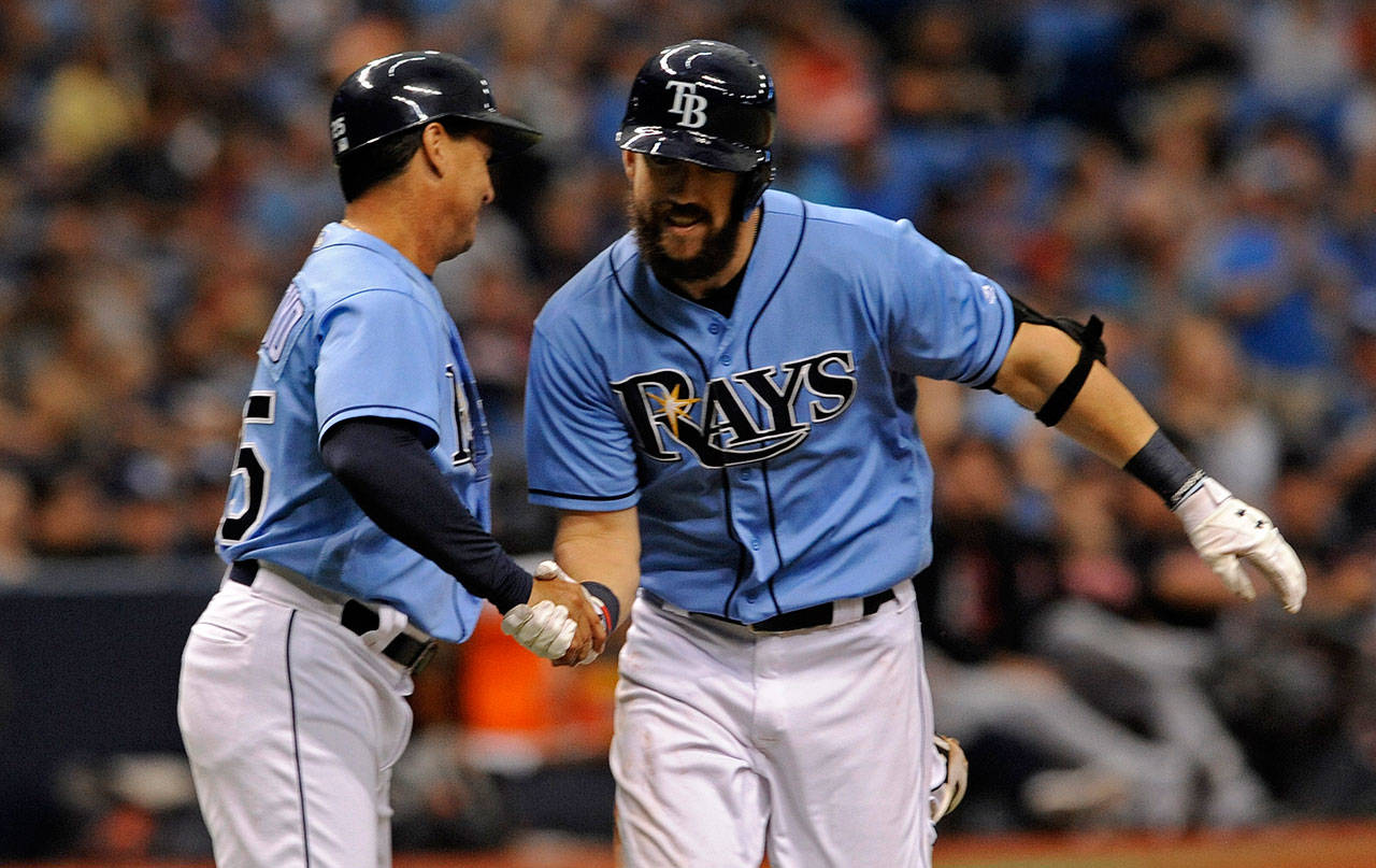 Tampa Bay Rays third-base coach Charlie Montoyo (left) congratulates Steven Souza Jr. after Souza hit his 25th home run of the season Sunday in St. Petersburg, Florida. (AP Photo/Steve Nesius)