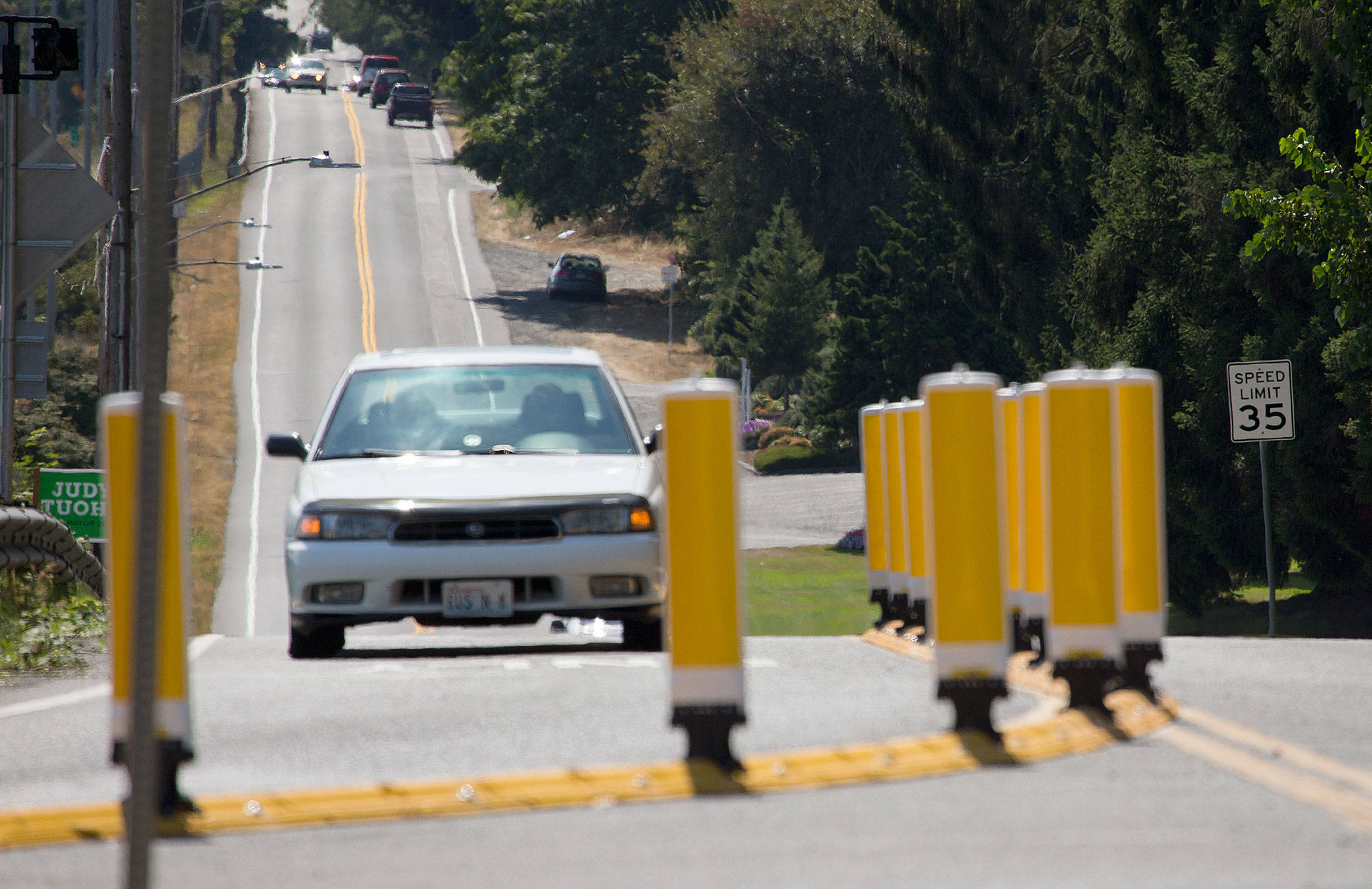 A raised curb and 14 reflective and flexible delineator posts steer drivers at the intersection where Broadway takes a sharp turn over a short bridge south of 41st Street in Everett. (Andy Bronson / The Herald)