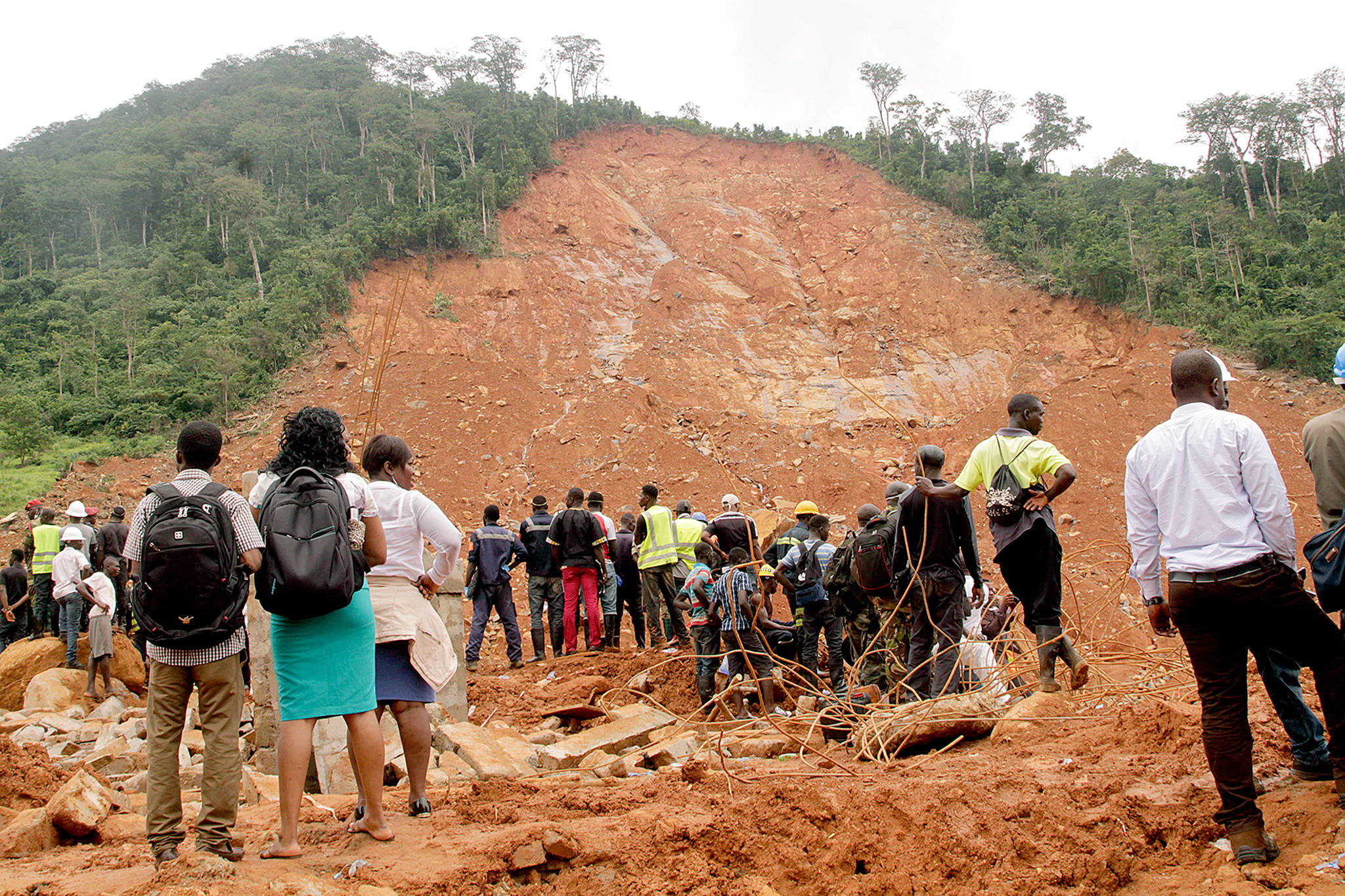 Volunteers wait at the scene of heavy flooding and mudslides in Regent, just outside of Sierra Leone’s capital of Freetown, on Tuesday. (AP Photo/ Kabba Kargbo)