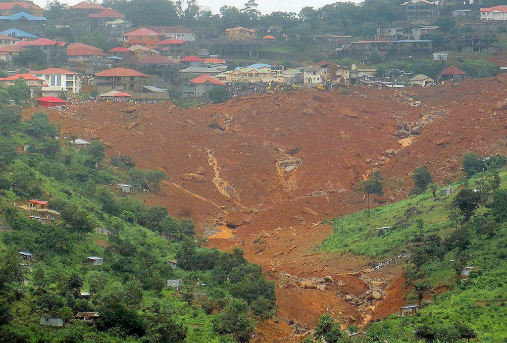 A mudslide in Regent, east of Freetown, Sierra Leone, on Monday. Mudslides and torrential flooding killed many people in and around Sierra Leone’s capital following heavy rains, with many victims thought to be trapped in homes buried under tons of mud. (AP Photo/ Manika Kamara) 
