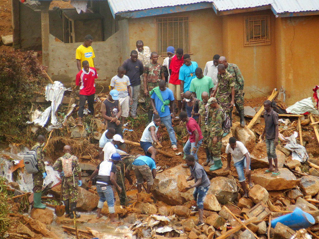 Volunteers search for bodies from the scene of heavy flooding and mudslides in Regent, just outside of Sierra Leone’s capital Freetown on Tuesday. (AP Photo/ Manika Kamara)
