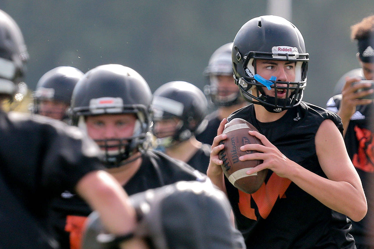 Monroe quarterback Jaedyn Prewitt (far right) drops back to pass during practice on Aug. 16, 2017, at Monroe High School. (Kevin Clark / The Herald)