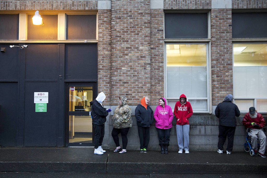 People wait in line for the Evergreen Treatment Services methadone clinic to open in Hoquiam on June 15. (AP Photo/David Goldman)
