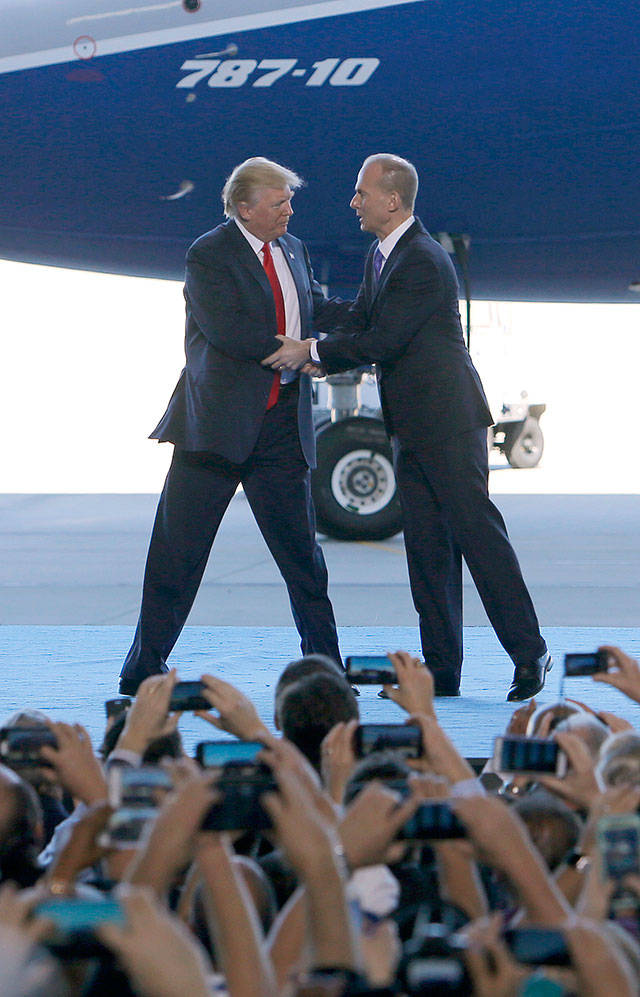 President Donald Trump greets Boeing CEO Dennis Muilenburg on Feb. 17 in North Charleston, South Carolina. (AP Photo/Mic Smith)