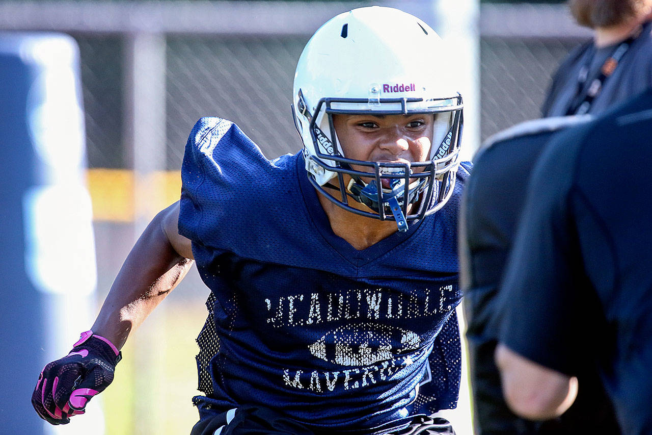 Meadowdale senior Jashon Butler attacks a pad during practice Aug. 17, 2017, at Meadowdale High School in Lynnwood. (Kevin Clark / The Herald)