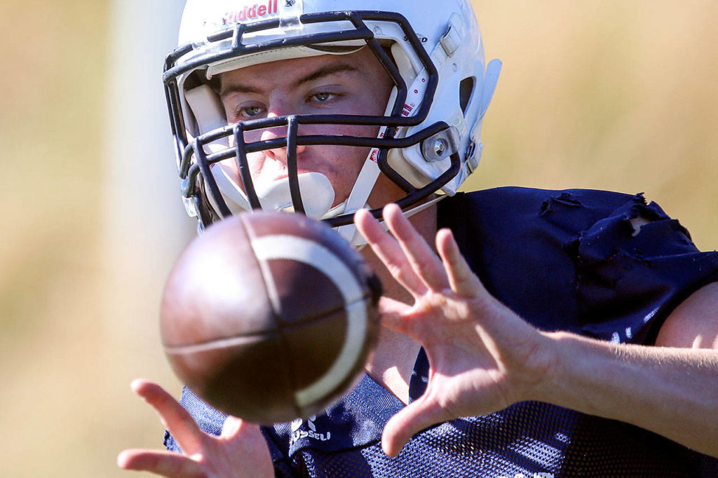 Meadowdale senior Will Schafer makes a catch during practice Aug. 17, 2017, at Meadowdale High School in Lynnwood. (Kevin Clark / The Herald)
