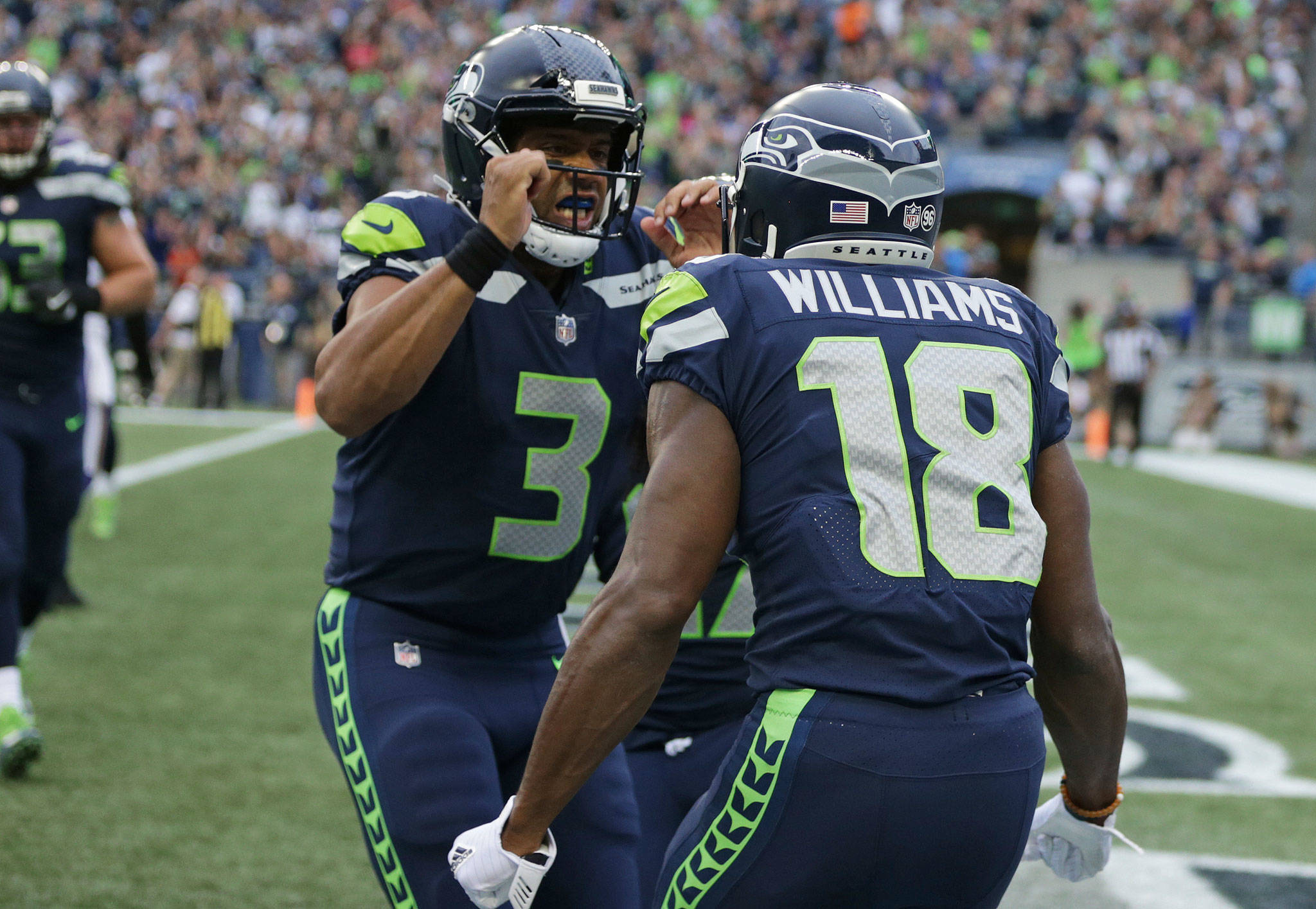 Seahawks wide receiver Kasen Williams (18) celebrates with quarterback Russell Wilson (3) after a touchdown in the first half of a preseason game against the Vikings on Aug. 18, 2017, in Seattle. (AP Photo/Scott Eklund)