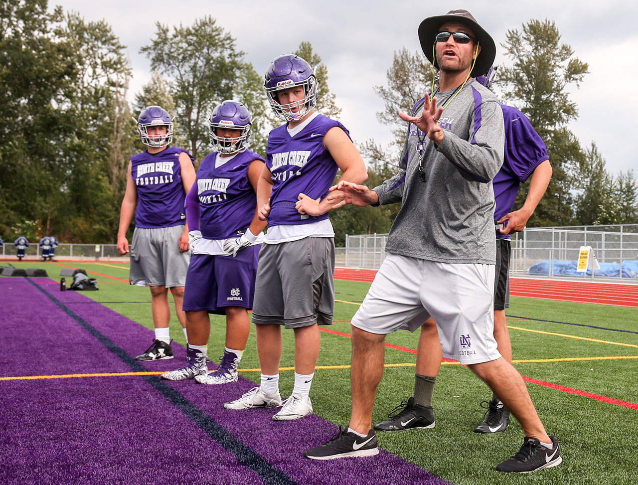 Torrey Myers, head coach, instructs during practice Friday afternoon at North Creek High School in Bothell on August 18, 2017. (Kevin Clark / The Herald)