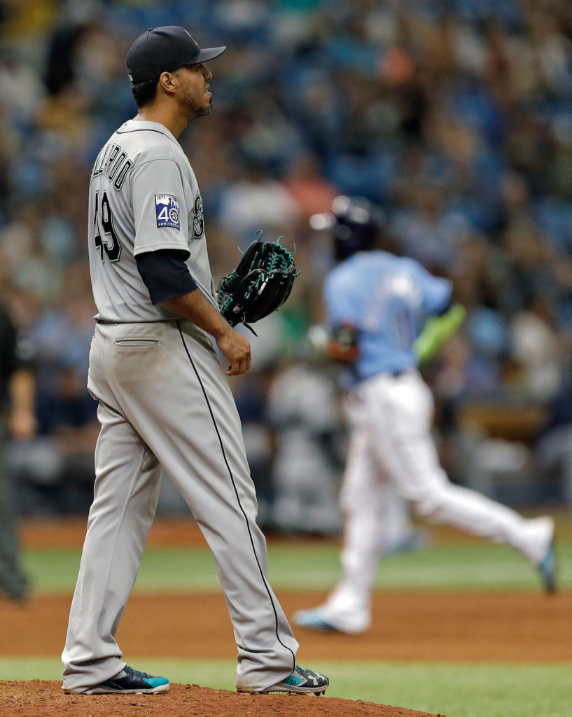 Seattle Mariners starting pitcher Yovani Gallardo watches as Tampa Bay Rays’ Adeiny Hechavarria runs around the bases after Hechavarria hit a two-run home run during the seventh inning, Sunday, Aug. 20, 2017, in St. Petersburg, Fla. (AP Photo/Chris O’Meara)
