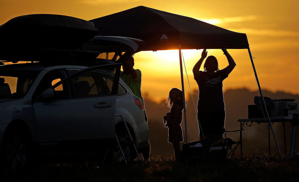 A family at sunrise prepares for the solar eclipse on Monday near Hopkinsville, Kentucky. The location is in the path of totality and at the point of greatest intensity. (AP Photo/Mark Humphrey) 
