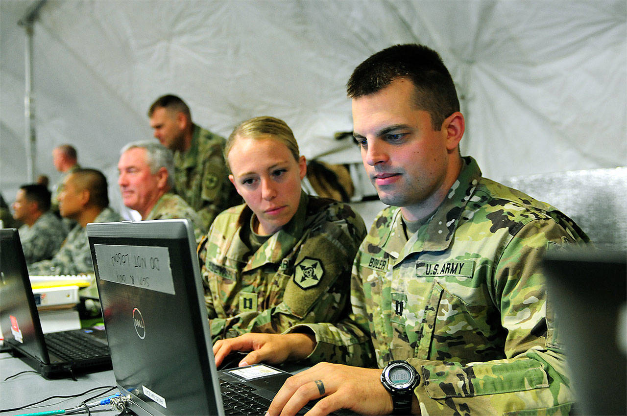 Capt. Trista Buszyenski and Capt. Thomas Boler, of the 364th Expeditionary Sustainment Command, supports the 593rd ESC during joint operation Talisman Saber 17 on July 19 at Joint Base Lewis-McChord. (Brigida Sanchez / 364th Expeditionary Sustainment Command)