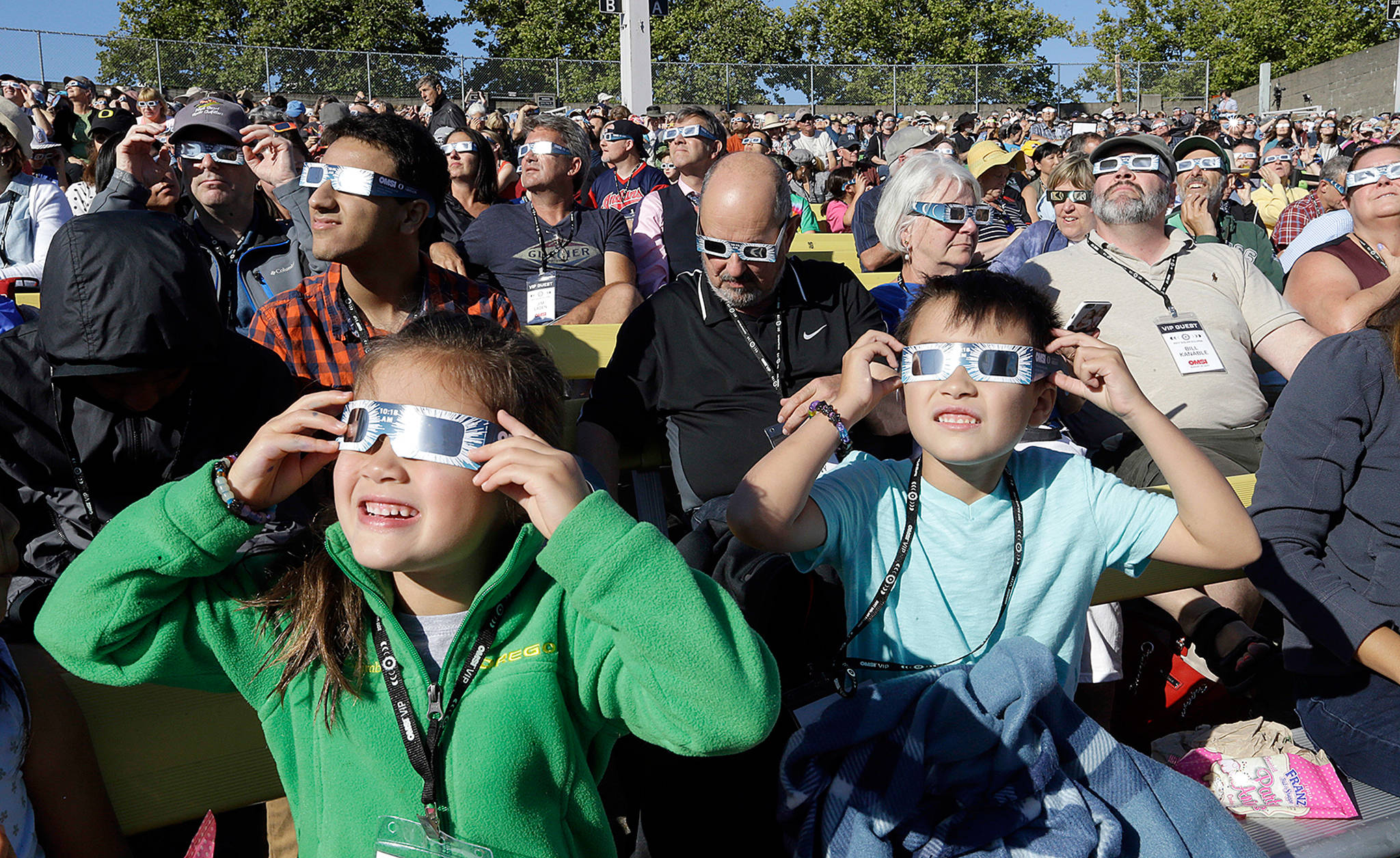 A crowd wears protective glasses as they watch the beginning of the solar eclipse from Salem, Oregon, on Monday. (AP Photo/Don Ryan)