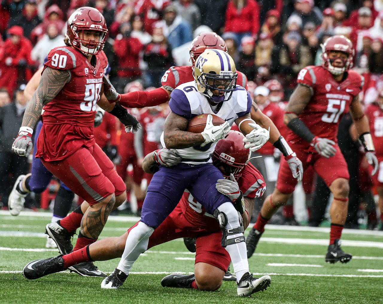 Washington wide receiver Chico McClatcher runs through the Washington State defense during last season’s Apple Cup in Pullman. (Kevin Clark / The Herald)