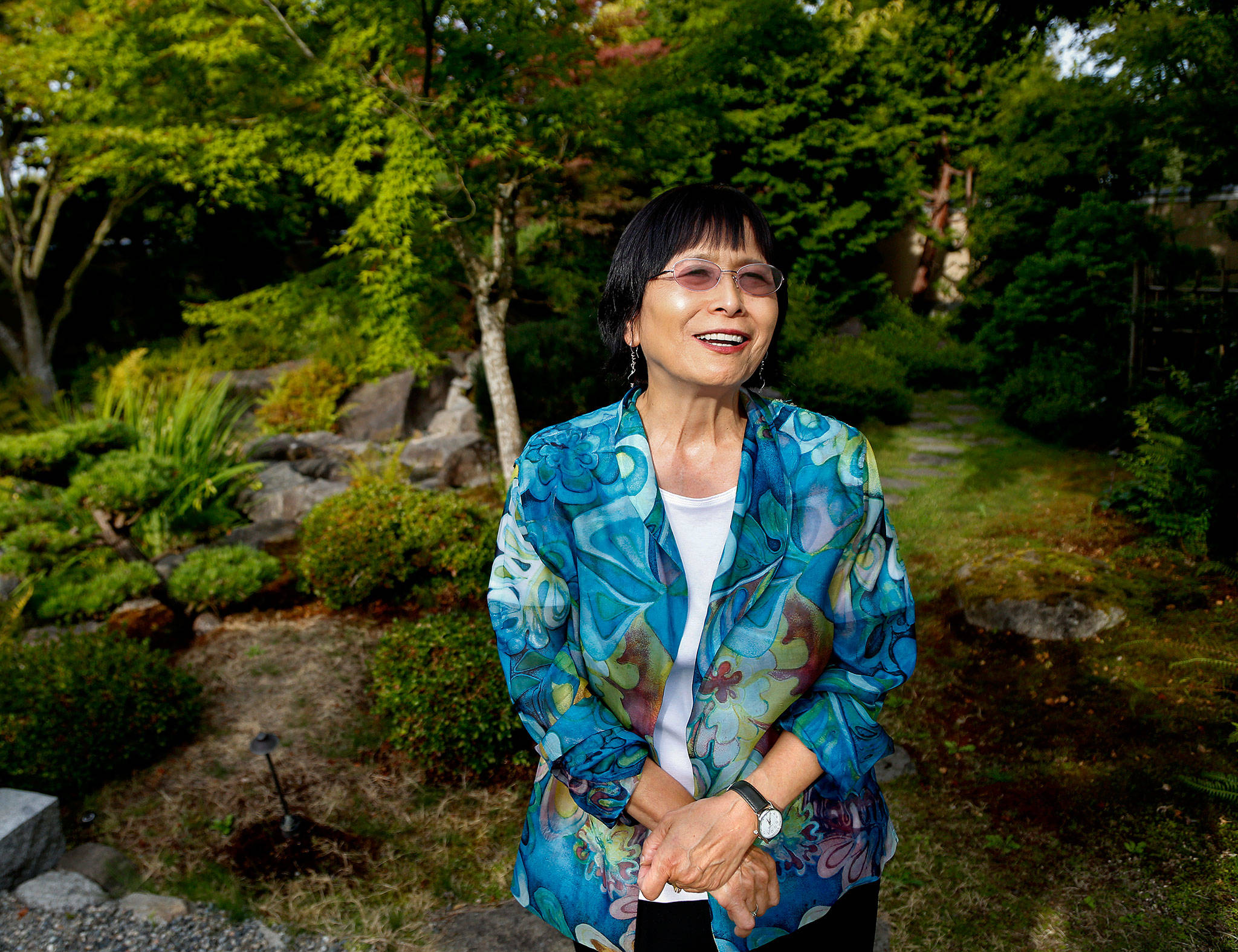 Mayumi Smith, director of Nippon Business Institute at EvCC since 1990, walks in the lovely Nishiyama Japanese Garden outside the institute this week, just a day away from retirement. (Dan Bates / The Herald)