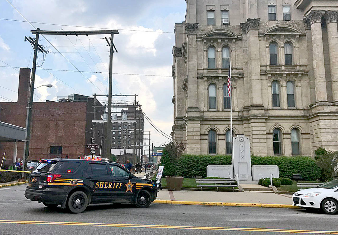 The scene of the ambush-style shooting of Jefferson County Judge Joseph Bruzzese Jr. as he walked toward the Jefferson County Courthouse in Steubenville, Ohio. Bruzzese was wounded and the suspect was killed. (WTOV-TV via AP)