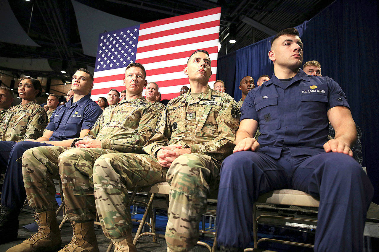 Members of the U.S. military listen as President Donald Trump speaks at Fort Myer in Arlington, Virginia, on Monday during an address to the nation about Afghanistan strategy. (AP Photo/Carolyn Kaster)