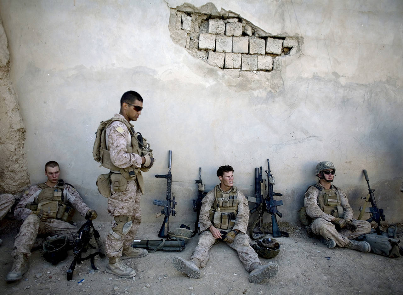 In this 2011 photo, Marines take a break during a patrol in Sangin, south of Kabul, Afghanistan. (AP Photo/Dusan Vranic)
