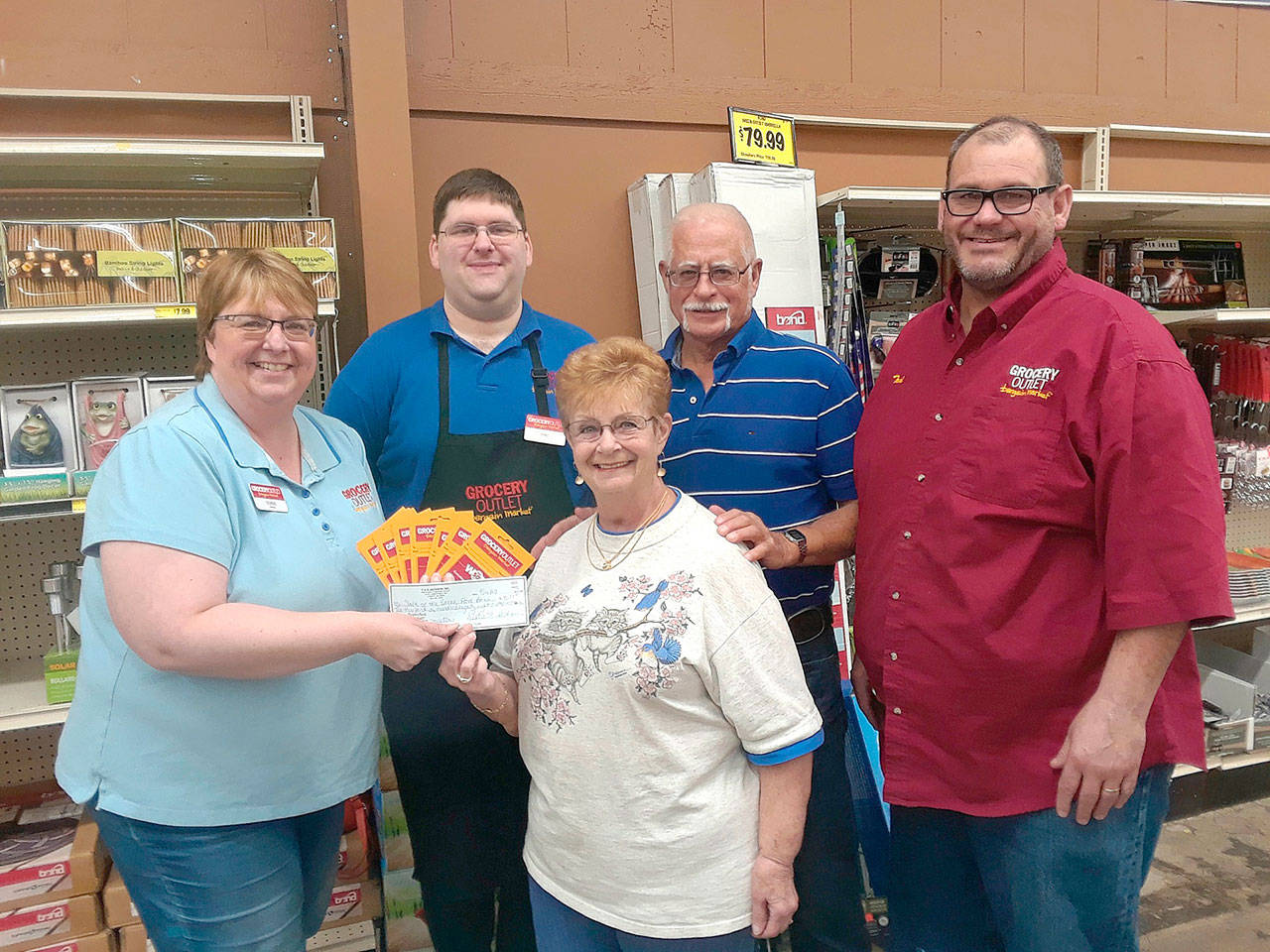 Grocery Outlet recently donated to Salt of the Earth Food Bank and Soup Kitchen. Pictured from left are grocery owner Debbie Jackson, employee Eric Foreman, food bank representatives Sandra and David Richards, and grocery owner Todd Jackson.
