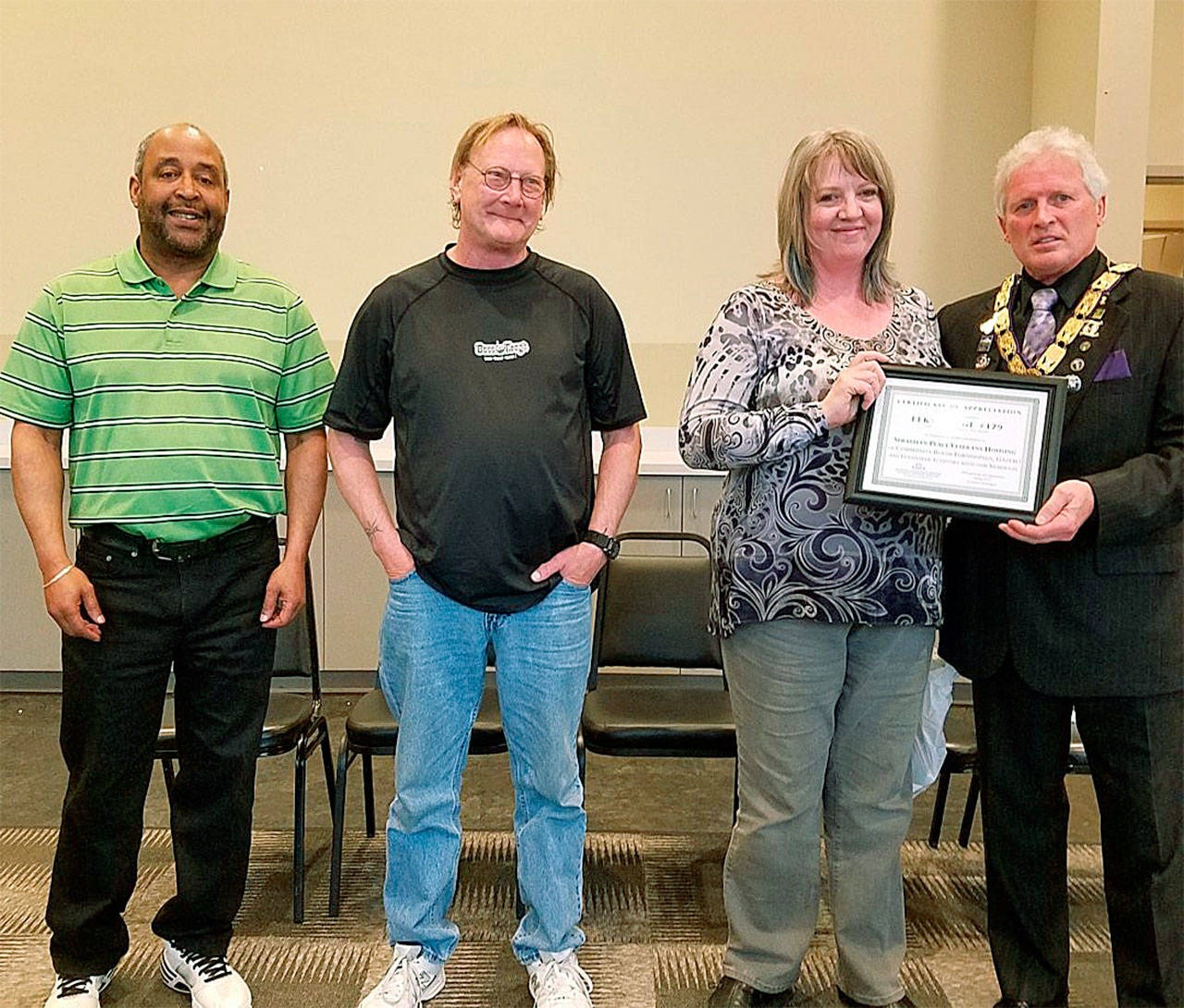 Victoria Mason (second from right) from Catholic Community Services presents a Certificate of Appreciation on behalf of Sebastian Place to Everett Elks Lodge 479 Exalted Ruler Dennis Andersen. Also pictured are (from left) Ken Berry and Gerry Olsen. (Contributed photo)