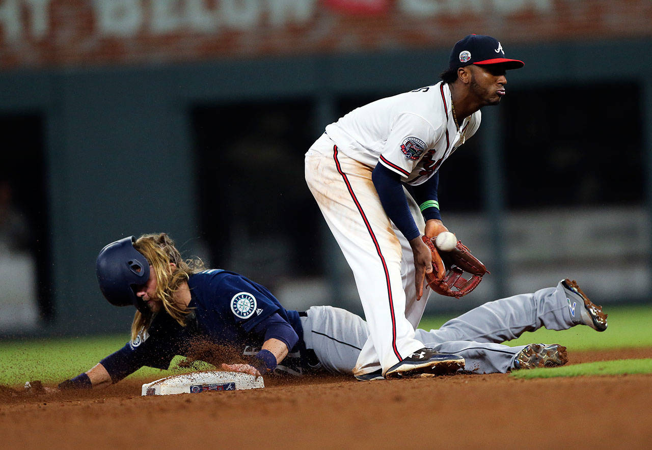 Seattle’s Taylor Motter steals seconds base as Atlanta’s Ozzie Albies handles the late throw in the eighth inning of Wednesday’s game in Atlanta. (AP Photo/John Bazemore)