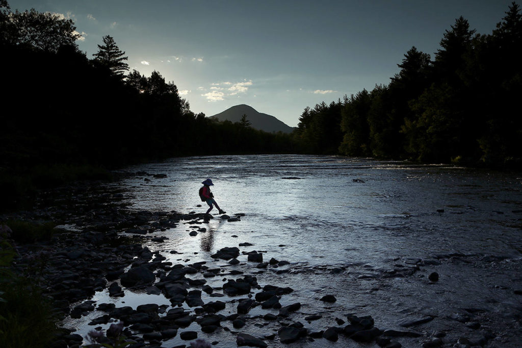 In this Aug. 8 photo, a youngster explores the Penobscot River’s East Branch at the new Katahdin Woods and Waters National Monument near Patten, Maine. (AP Photo/Robert F. Bukaty)
