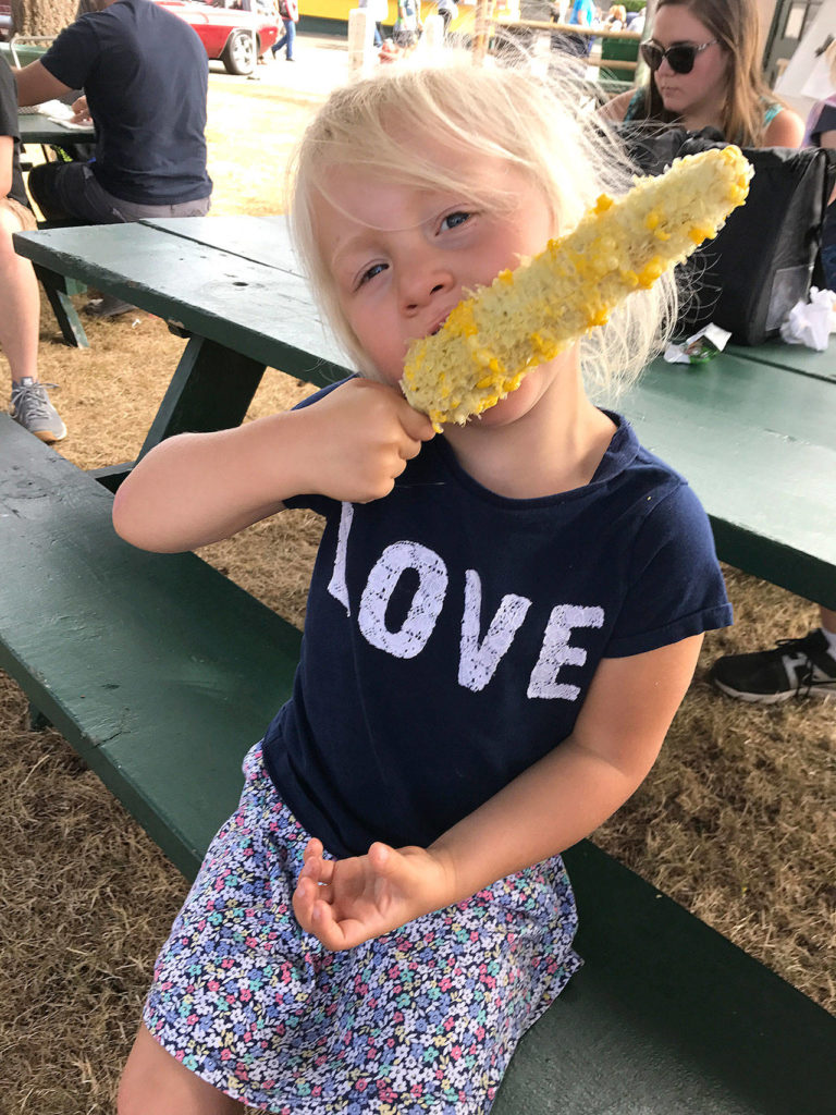 Paige devours corn on the cob, offered by the Nile Shriners of Mountlake Terrace, at the fair. (Family photo)
