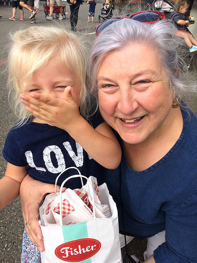The author shares Fisher fair scones with her 3-year-old granddaughter, Paige Snitily, at the Evergreen State Fair. (Family photo)