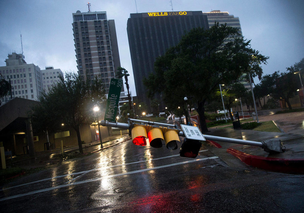 A damaged stop light blocks a street as Hurricane Harvey makes landfall in Corpus Christi, Texas, on Friday. (Nick Wagner/Austin American-Statesman via AP)
