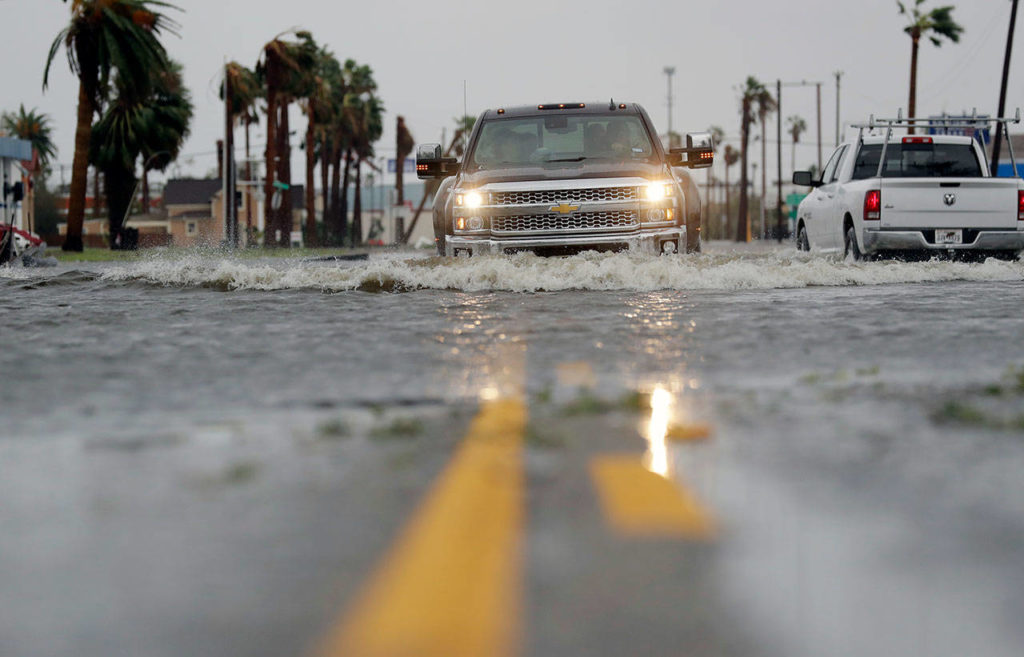A car moves through flood waters left behind by Hurricane Harvey on Saturday in Aransas Pass, Texas. (AP Photo/Eric Gay)
