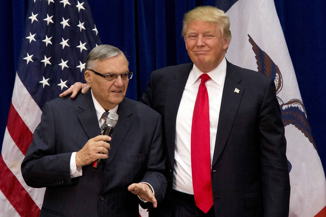 In this 2016 photo, then-Republican presidential candidate Donald Trump is joined by Joe Arpaio, the sheriff of metro Phoenix, at a campaign event in Marshalltown, Iowa. (AP Photo/Mary Altaffer, File)