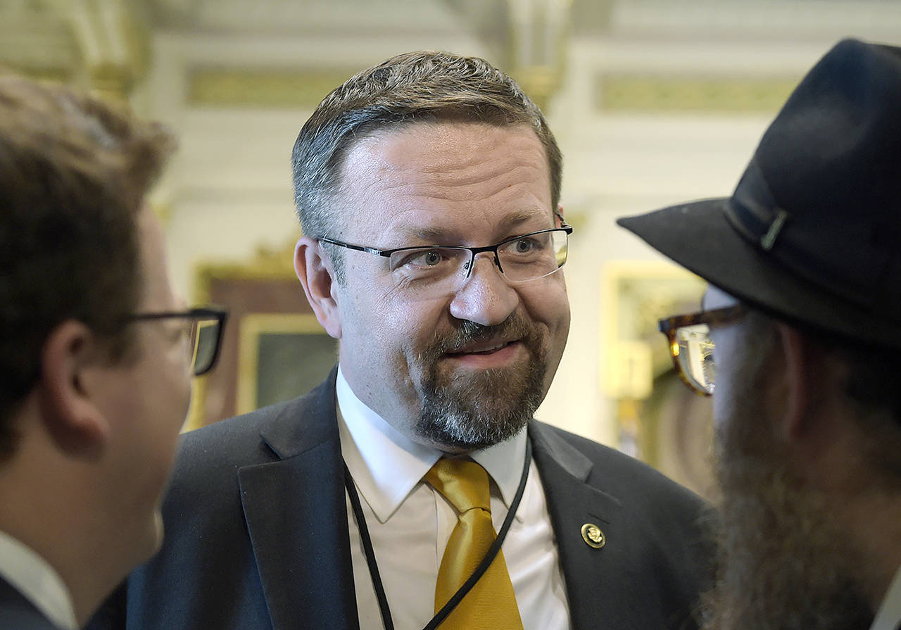 In this May 2 photo, deputy assistant to President Trump, Sebastian Gorka, talks with people in the Treaty Room in the Eisenhower Executive Office Building on the White House complex in Washington during a ceremony commemorating Israeli Independence Day. (AP Photo/Susan Walsh, File)