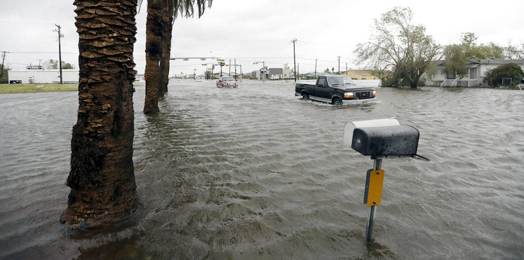 A truck moves through flood waters left behind by Hurricane Harvey on Saturday in Aransas Pass, Texas. (AP Photo/Eric Gay)
