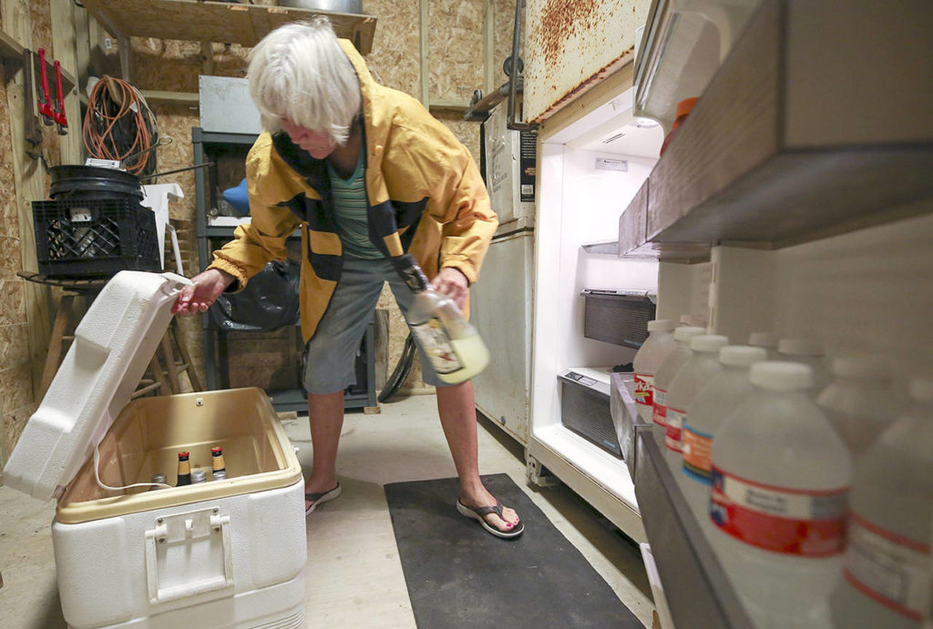 Carolyn Price empties a fridge on the lower level of her property in Matagorda, Texas before Hurricane Harvey makes landfall Friday. (Godofredo A. Vasquez/Houston Chronicle via AP)
