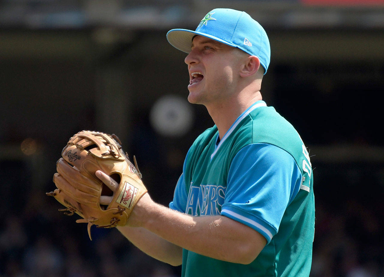 Seattle Mariners third baseman Kyle Seager reacts after making an error in the first inning of Sunday’s game in New York. The Mariners made five errors in the frame. (AP Photo/Bill Kostroun)