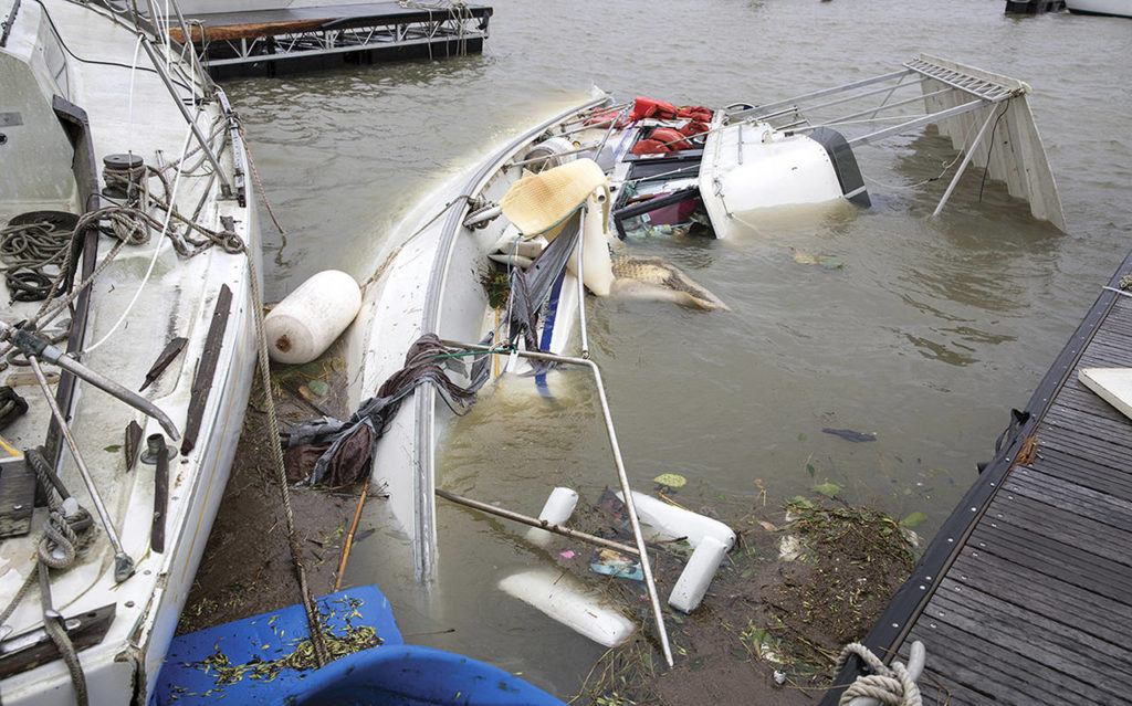 A boat lays on it’s side almost completely underwater after Hurricane Harvey hit a harbor in Port Lavaca, Texas, on Sunday. (Ana Ramirez/The Victoria Advocate via AP)
