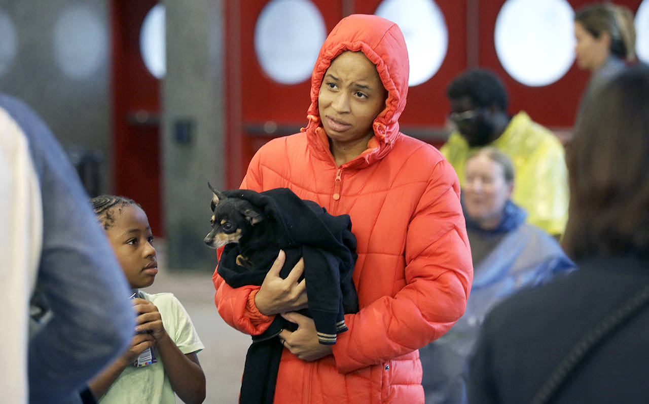 D’Ona Spears reacts as she is told that she cannot bring her dog Missy into the shelter for flood evacuees with her daughter Natalie at the convention center in downtown Houston, Texas, on Sunday. (AP Photo/LM Otero)