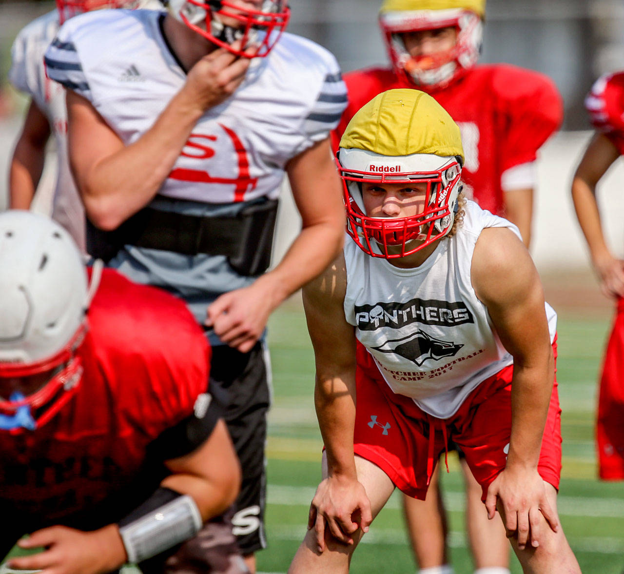 Snohomish’s Keegan Stich (far right) awaits the snap during practice Monday afternoon at Snohomish High School. Stich and the Panthers are hoping to return to the postseason in 2017. (Kevin Clark / The Herald)