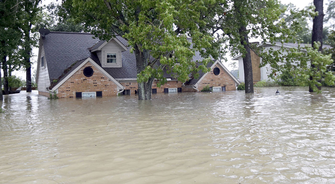 A home is surrounded by floodwaters from Tropical Storm Harvey on Monday in Spring, Texas. (AP Photo/David J. Phillip)