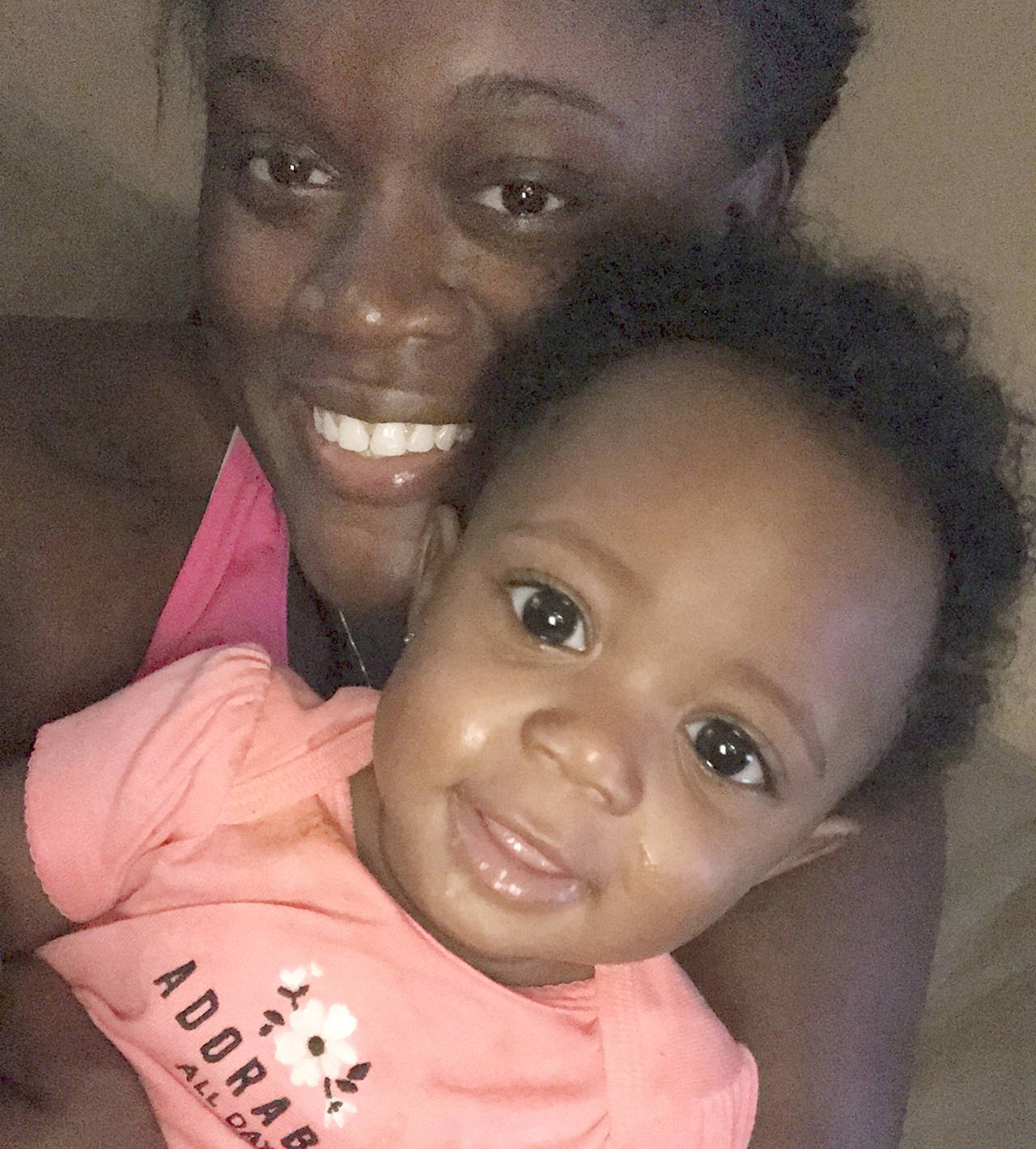 Bajauh Henix takes a photo with her daughter Paige Booth on Monday after being reunited nearly four hours after the two evacuated from their home in Houston. (Bajauh Henix via AP)