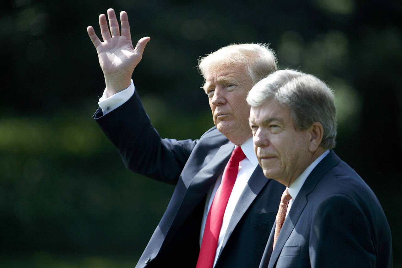 President Donald Trump, accompanied by Sen. Roy Blunt, R-Mo., waves as they walk to board Marine One on the South Lawn of the White House in Washington on Wednesday. (AP Photo/Evan Vucci)