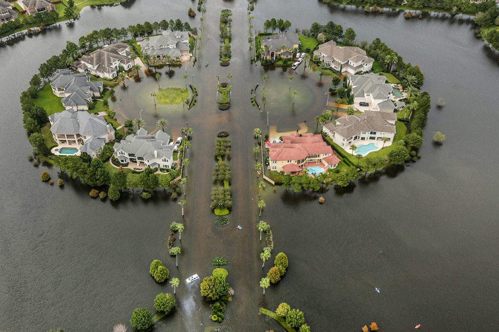 Floodwaters fill the road running through the Lakes On Eldridge North subdivision in the aftermath of Tropical Storm Harvey on Wednesday in Houston. (Brett Coomer/Houston Chronicle via AP)
