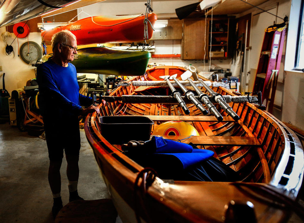 At his home in Marysville, Jaquette keeps several lightweight kayaks suspended from the ceiling of his garage, and one very special 17-foot wooden rowboat on a trailer. He built the wood boat over about two years. It is cedar lapstrake with spruce trim. Painted in red caps, it bears a special name, especially considering its creator is a lawyer: THURGOOD. (Dan Bates / The Herald)
