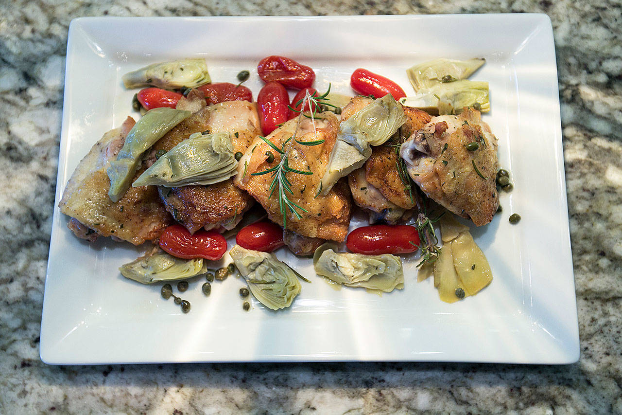 Chicken with charred-rosemary vinaigrette is livened up with artichokes, grape tomatoes and capers. (Kathleen Galligan/Detroit Free Press)