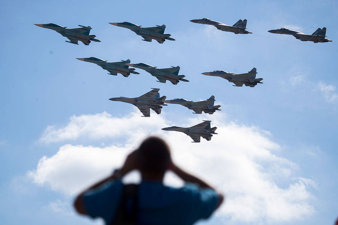 A man watches Russian military jets performing in Alabino, outside Moscow, earlier this summer. (AP file)